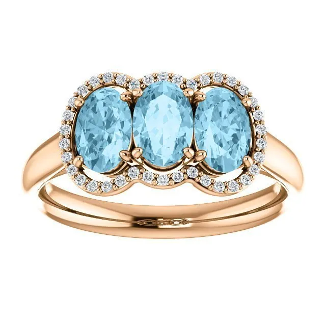 14KT GOLD 1.23 CTW AQUAMARINE & .10 CTW DIAMOND 3 STONE OVAL HALO RING