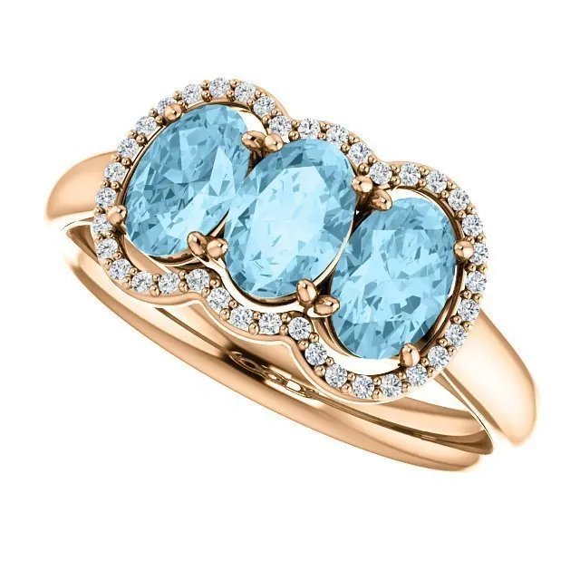 14KT GOLD 1.23 CTW AQUAMARINE & .10 CTW DIAMOND 3 STONE OVAL HALO RING