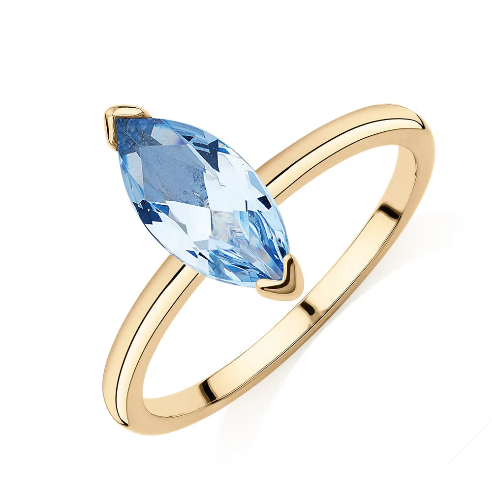 Dress ring with aquamarine simulant in 10 carat yellow gold