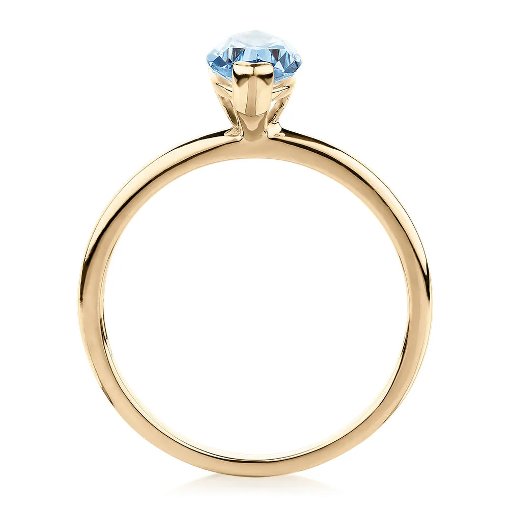 Dress ring with aquamarine simulant in 10 carat yellow gold