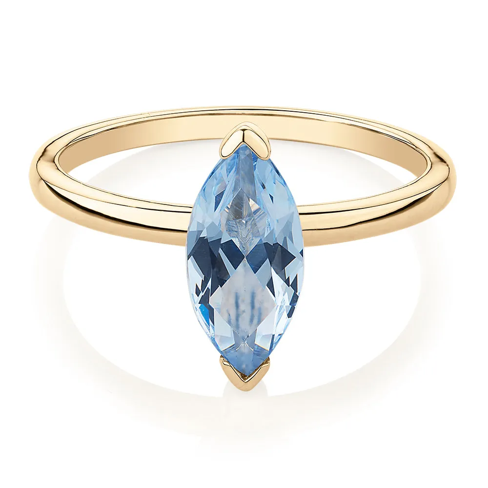 Dress ring with aquamarine simulant in 10 carat yellow gold