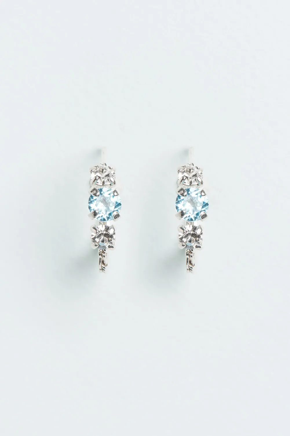 Wouters & Hendrix - Silver Hoop Earrings with Aquamarine and Clear Crystal Trilogy Stones